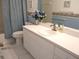 Bathroom with a white countertop vanity, framed mirror, and tiled floors at 11470 Sw 139Th St, Dunnellon, FL 34432