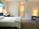 Bright bedroom featuring neutral colors, carpet flooring, and an en suite bathroom at 11470 Sw 139Th St, Dunnellon, FL 34432