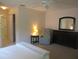 Cozy bedroom featuring a recliner, dresser, and natural light from the window at 11470 Sw 139Th St, Dunnellon, FL 34432