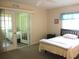 Well-lit bedroom featuring French doors and a view into an adjacent bedroom at 11470 Sw 139Th St, Dunnellon, FL 34432