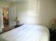 Bedroom featuring a queen sized bed with white bedding and an entry door at 11470 Sw 139Th St, Dunnellon, FL 34432
