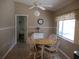 Cozy dining area featuring tile floors, a bright window, and room for gatherings, connecting to kitchen at 11470 Sw 139Th St, Dunnellon, FL 34432