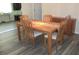 Dining room featuring wood floors and a wooden table with four chairs at 11470 Sw 139Th St, Dunnellon, FL 34432