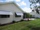 Back exterior view featuring awnings, a screened in patio, and a chain-link fence at 11470 Sw 139Th St, Dunnellon, FL 34432
