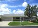 Charming single-story home featuring a well-maintained lawn and a mature tree providing shade at 11470 Sw 139Th St, Dunnellon, FL 34432