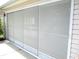 Garage doors with screens on a home exterior at 11470 Sw 139Th St, Dunnellon, FL 34432