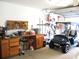 Functional garage workspace with workbench and golf cart parking at 11470 Sw 139Th St, Dunnellon, FL 34432