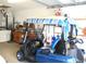 Garage featuring a golf cart and an area for projects at 11470 Sw 139Th St, Dunnellon, FL 34432