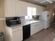 Bright kitchen with white cabinets and appliances, a convenient dishwasher, and ample counter space at 11470 Sw 139Th St, Dunnellon, FL 34432