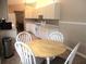 Bright kitchen with white cabinets, tile floors and a dining area with seating for enjoying casual meals at 11470 Sw 139Th St, Dunnellon, FL 34432