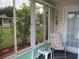 Enclosed lanai with a view of the backyard and a single chair at 11470 Sw 139Th St, Dunnellon, FL 34432
