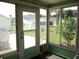 Screened lanai featuring sliding windows offering outdoor view and tile flooring at 11470 Sw 139Th St, Dunnellon, FL 34432