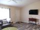 Bright living room featuring wood floors, a neutral color palette, and a modern ceiling fan at 11470 Sw 139Th St, Dunnellon, FL 34432