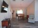 Inviting living room with wood flooring, natural light, and an open floor plan to the dining area at 11470 Sw 139Th St, Dunnellon, FL 34432