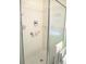 White tiled shower with detachable shower head and soap dispenser at 11470 Sw 139Th St, Dunnellon, FL 34432