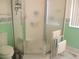 Modern bathroom with glass shower and matching green accents at 11470 Sw 139Th St, Dunnellon, FL 34432