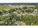Expansive aerial view of a residential neighborhood with scattered homes surrounded by mature trees and open fields at 12681 Se 54Th Ave, Belleview, FL 34420