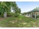 Spacious backyard featuring lush green grass and mature trees, offering privacy and serenity at 12681 Se 54Th Ave, Belleview, FL 34420