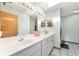 Bathroom features dual sinks, a spacious vanity, and tile flooring at 12681 Se 54Th Ave, Belleview, FL 34420
