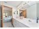 Bright bathroom features a double sink vanity and a doorway that leads into the bedroom at 12681 Se 54Th Ave, Belleview, FL 34420