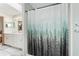 This bathroom displays a shower with a decorative forest shower curtain, and double sink vanity at 12681 Se 54Th Ave, Belleview, FL 34420