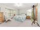 Bedroom with bright windows, light walls, ceiling fan, and neutral carpet at 12681 Se 54Th Ave, Belleview, FL 34420