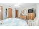 Bedroom featuring a dresser, television, ceiling fan, and hardwood closet at 12681 Se 54Th Ave, Belleview, FL 34420
