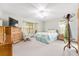 Bedroom with bright windows, light walls, ceiling fan, and neutral carpet at 12681 Se 54Th Ave, Belleview, FL 34420