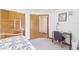 Bedroom featuring double closets, an open door, and a ceiling fan at 12681 Se 54Th Ave, Belleview, FL 34420