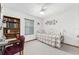 Bedroom with a daybed, a ceiling fan, and a bookshelf near the window at 12681 Se 54Th Ave, Belleview, FL 34420