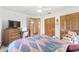 Bedroom with a bed, TV, chest of drawers, closet, and a ceiling fan at 12681 Se 54Th Ave, Belleview, FL 34420