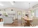 Bright dining area showcasing hardwood floors, a decorative chandelier, and views into the kitchen at 12681 Se 54Th Ave, Belleview, FL 34420