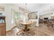 Cozy dining area with a bay window, chandelier lighting, and hardwood floors at 12681 Se 54Th Ave, Belleview, FL 34420