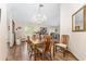 Light-filled dining room with chandelier, seating for six, and hardwood floors at 12681 Se 54Th Ave, Belleview, FL 34420