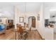 Dining room with hardwood floors, chandelier lighting, and view into the living room at 12681 Se 54Th Ave, Belleview, FL 34420