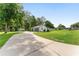 Long driveway leading to a home with a detached garage and carport at 12681 Se 54Th Ave, Belleview, FL 34420