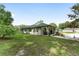 Charming home with a well-maintained lawn, a cozy porch swing, and a peaceful ambiance at 12681 Se 54Th Ave, Belleview, FL 34420