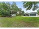View of backyard showing a detached carport and shed at 12681 Se 54Th Ave, Belleview, FL 34420