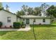 Inviting entrance featuring a green door and manicured landscaping at 12681 Se 54Th Ave, Belleview, FL 34420