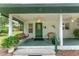 Charming front porch with a swing, seating, and ceiling fans at 12681 Se 54Th Ave, Belleview, FL 34420