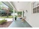 Wide front porch with a swing and seating overlooking the property at 12681 Se 54Th Ave, Belleview, FL 34420