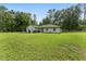 Charming single-story home with a well-manicured lawn and mature trees providing shade and privacy at 12681 Se 54Th Ave, Belleview, FL 34420
