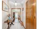 Bright hallway with a table, tile floor, artwork and provides access to the office at 12681 Se 54Th Ave, Belleview, FL 34420