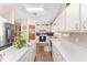 Bright kitchen with white cabinets, stainless steel refrigerator, and modern appliances at 12681 Se 54Th Ave, Belleview, FL 34420