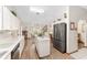 Spacious kitchen with white cabinets, stainless steel fridge, island and dining area at 12681 Se 54Th Ave, Belleview, FL 34420