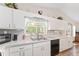 The kitchen features white cabinets, a large window over the sink, and ample counter space at 12681 Se 54Th Ave, Belleview, FL 34420