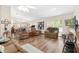 Spacious living room with hardwood floors, a ceiling fan, and large windows offering ample natural light at 12681 Se 54Th Ave, Belleview, FL 34420