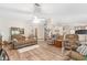 Open living room with hardwood floors, comfortable furniture, and access to other rooms at 12681 Se 54Th Ave, Belleview, FL 34420