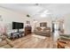 Cozy living room with hardwood floors, fireplace, television, and comfortable seating at 12681 Se 54Th Ave, Belleview, FL 34420