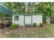Exterior view of the backyard shed with green trim and siding, offering storage solutions at 12681 Se 54Th Ave, Belleview, FL 34420